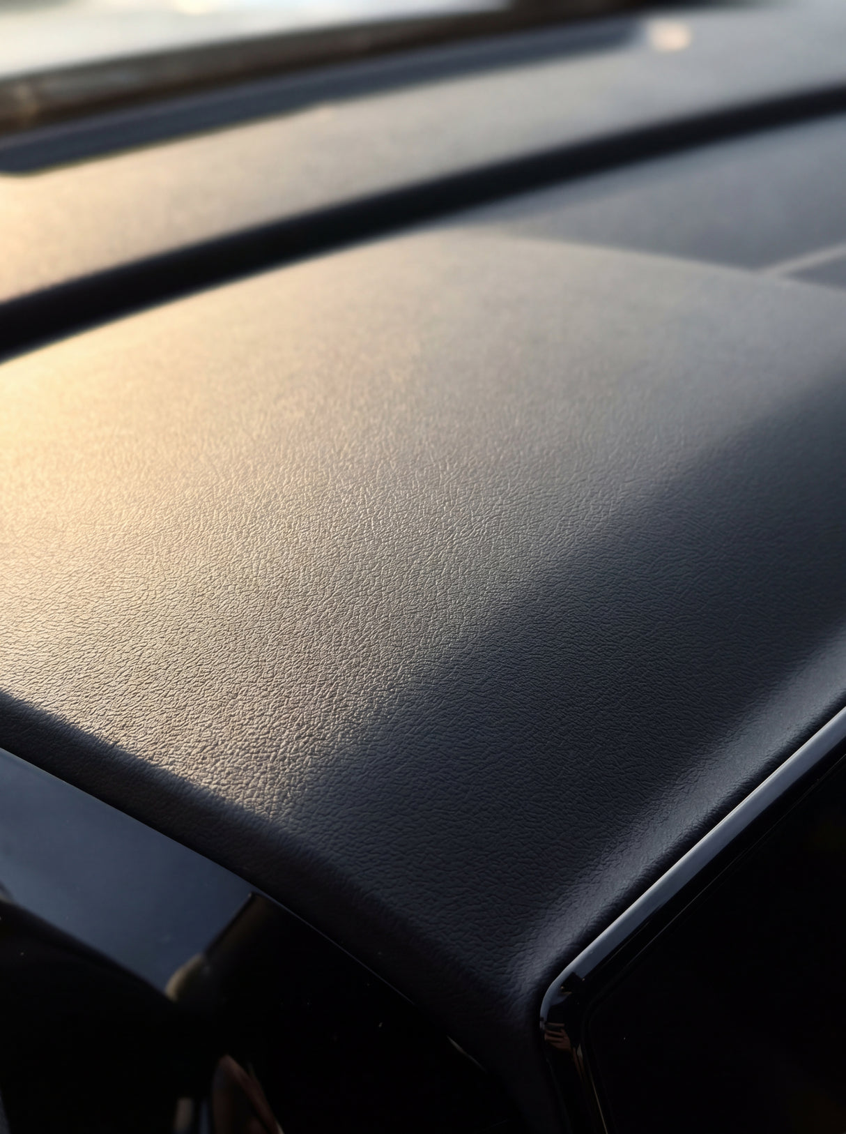 Behandelte Armaturenbrett-Oberflaeche mit seidenmatter Koch-Chemie Top Star Ts Pflege, Makro-Detail