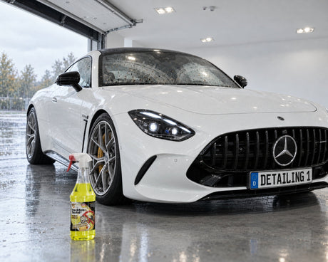 TUGA Chemie Insekten-Teufel in front of a Mercedes-AMG GT with bug residue on the windscreen — shown in the article “5 reasons your windscreen smears after summer”